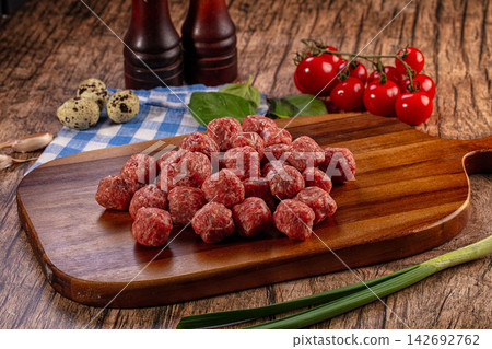Raw Meatballs on Cutting Board with Ingredients Raw Meatballs on Cutting Board with Ingredients 142692762