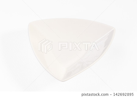 White triangular ceramic bowl on clean white background with soft shadow and glossy finish White triangular ceramic bowl on clean white background with soft shadow and glossy finish 142692895