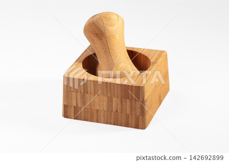 Wooden mortar and pestle with bamboo construction, natural grain texture, on white background, close up Wooden mortar and pestle with bamboo construction, natural grain texture, on white background, close up 142692899