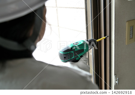 Renovation: Image of workers installing double-glazed windows. Renovation: Image of workers installing double-glazed windows. 142692918