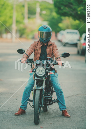 Concept of a motorcyclist wearing a safety helmet Concept of a motorcyclist wearing a safety helmet 142693992