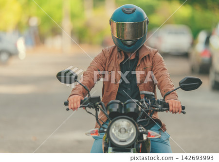 Concept of rider wearing a safety helmeton the road Concept of rider wearing a safety helmeton the road 142693993