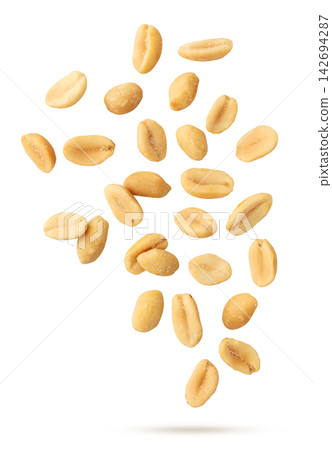 Salted peanuts flying close-up on a white background. Isolated Salted peanuts flying close-up on a white background. Isolated 142694287
