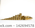 old & used gold coins stack up with small golden purse in white background 142694578