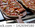 home made ellipse pan pizza on served 142694580