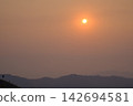 sunset view from the mountain topphoto has focused on a tree branch and partly blur on other subject 142694581
