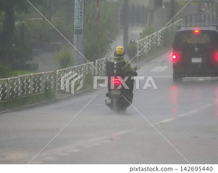 Motorcycles riding in the rain Motorcycles riding in the rain 142695440