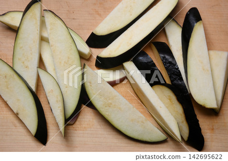 Eggplant cut on a cutting board Eggplant cut on a cutting board 142695622