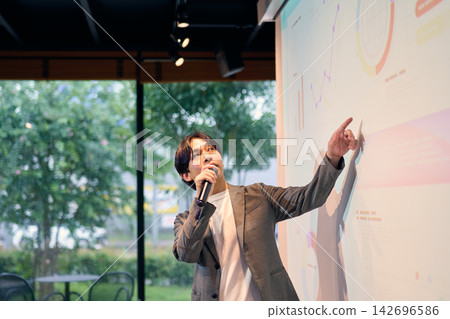 A man giving a presentation on a projector A man giving a presentation on a projector 142696586