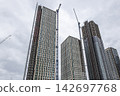 Skyscrapers under construction in urban city 142697768
