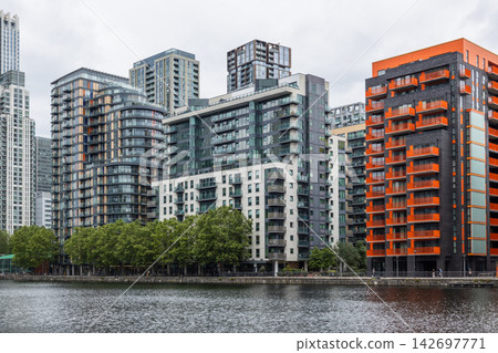 Apartment blocks along dockside in urban district, London, UK Apartment blocks along dockside in urban district, London, UK 142697771