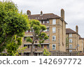 Traditional yellow brick council housing block 142697772