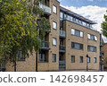 Contemporary residential block with glass balconies 142698457