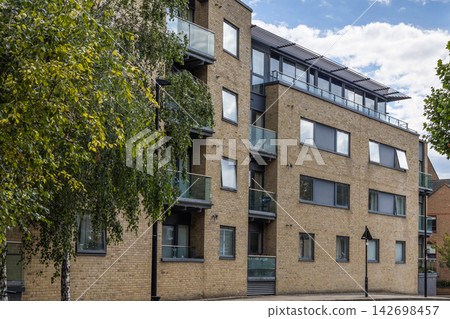 Contemporary residential block with glass balconies 142698457