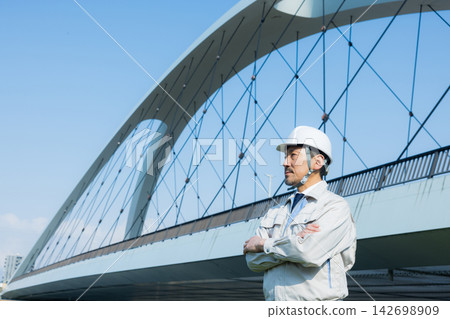 A man in his 50s working on site A man in his 50s working on site 142698909