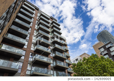 Urban residential high rise block with glass balconies Urban residential high rise block with glass balconies 142699005
