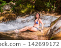 Travel Woman happy in a park spring near water 142699172