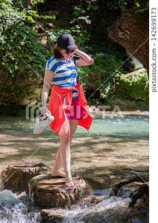 Travel Woman happy in a park spring near water Travel Woman happy in a park spring near water 142699173