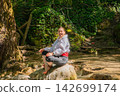 Travel Woman happy in a park spring near water 142699174