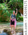 Travel Woman happy in a park spring near water 142699175