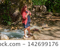 Travel Woman happy in a park spring near water 142699176