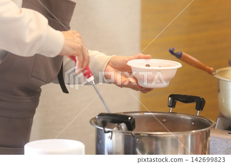 A woman serving soup A woman serving soup 142699823
