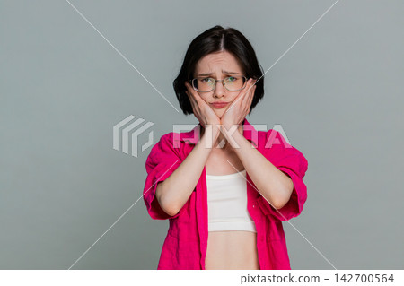 Woman sighs with disappointment covering face expressing sadness after failure or bad news reaction Woman sighs with disappointment covering face expressing sadness after failure or bad news reaction 142700564