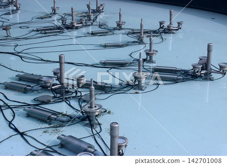 Wires for lighting and music, pipes for a jacuzzi effect around a water jet nozzles in a drained fountain  142701008