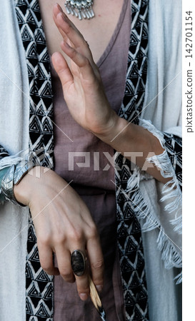 Female Hands with Silver Jewelry Holding Burned Palo Santo Stick During Spiritual Ritual Female Hands with Silver Jewelry Holding Burned Palo Santo Stick During Spiritual Ritual 142701154