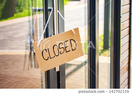 CLOSED sign on private shop window. Small local retail business closes because of financial and economic crisis. Entrepreneurs faces market changes CLOSED sign on private shop window. Small local retail business closes because of financial and economic crisis. Entrepreneurs faces market changes 142702159