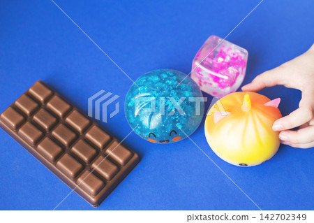 Child playing with sensory fidget toys and chocolate bar Child playing with sensory fidget toys and chocolate bar 142702349