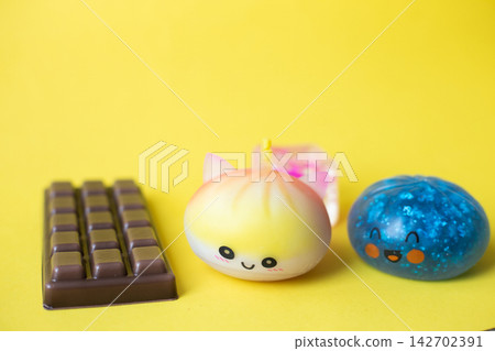 Cute squishy sensory stress relief toys on yellow background 142702391