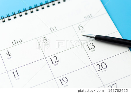 Calendar and ballpoint pen Calendar and ballpoint pen 142702425
