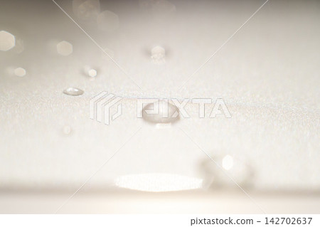 The shimmering light of the aurora within a water droplet. An artistic expression that conveys a refined and pure worldview. The shimmering light of the aurora within a water droplet. An artistic expression that conveys a refined and pure worldview. 142702637