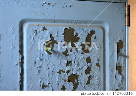 Image of peeling paint on a front door Image of peeling paint on a front door 142703316