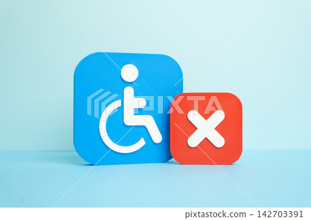 A disability symbol and a rejection or cancellation sign. Denial of status. Concept of bureaucratic obstacles and social injustice. Symbol of discrimination and refused rights. A disability symbol and a rejection or cancellation sign. Denial of status. Concept of bureaucratic obstacles and social injustice. Symbol of discrimination and refused rights. 142703391