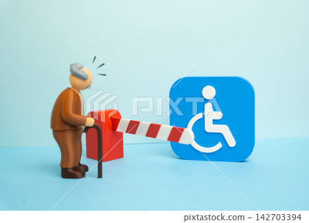 A disability symbol shielded from an elderly man with a cane. Concept of the impossibility of obtaining status and social assistance. Symbol of social exclusion and barriers. A disability symbol shielded from an elderly man with a cane. Concept of the impossibility of obtaining status and social assistance. Symbol of social exclusion and barriers. 142703394