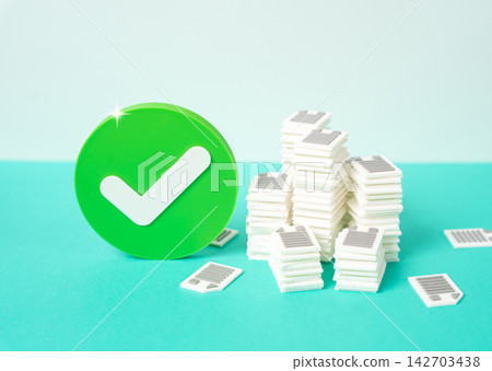 An approval checkmark and piles of documents and papers. Concept of bureaucracy and paperwork approval. Symbol of successful audit, verification and administrative process. An approval checkmark and piles of documents and papers. Concept of bureaucracy and paperwork approval. Symbol of successful audit, verification and administrative process. 142703438
