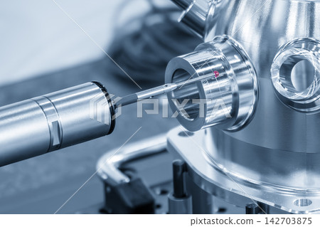 Close-up of a touch probe measuring an aluminum part in a blue tone scene Close-up of a touch probe measuring an aluminum part in a blue tone scene 142703875