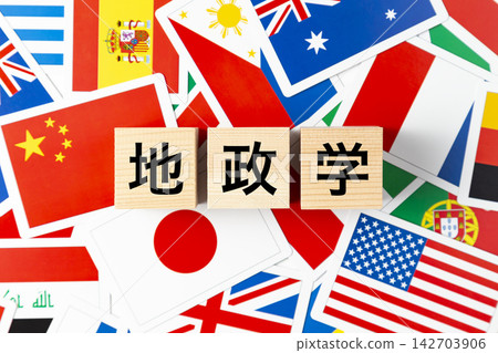 A block with the word "Geopolitics" written on it and various national flags. A block with the word "Geopolitics" written on it and various national flags. 142703906