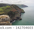 Coastal cliffs and sea view from Castle Rock, Valley of Rocks, Exmoor, Devon 142704603