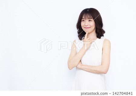 Woman thinking with a smile Woman thinking with a smile 142704841