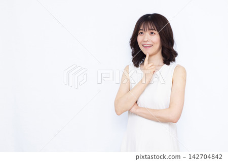 Woman thinking with a smile Woman thinking with a smile 142704842