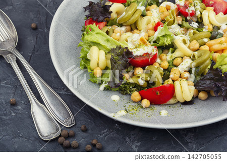 Mediterranean chickpea pasta salad with fresh vegetables Mediterranean chickpea pasta salad with fresh vegetables 142705055