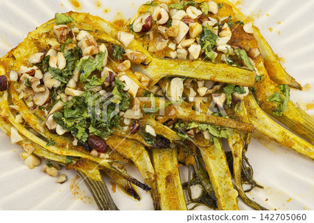 Gourmet roasted fennel with crunchy nuts and green herbs Gourmet roasted fennel with crunchy nuts and green herbs 142705060