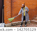 A Quirky Scene Featuring a Person in a Horse Mask Holding a Broom in Front of a Brick Wall, Blending Humor and Eccentricity 142705129