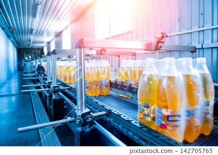 Modern strapping and transporting machine for packaging line at beverage plant. 142705765