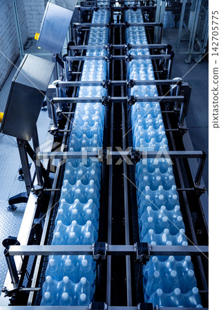 Modern strapping and transporting machine for packaging line at beverage plant. Modern strapping and transporting machine for packaging line at beverage plant. 142705775