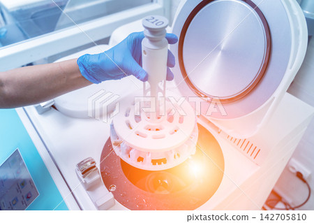 Laboratory assistant works with microwave hybrid tissue processor at the modern laboratory. Laboratory assistant works with microwave hybrid tissue processor at the modern laboratory. 142705810