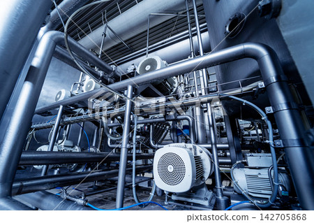 Modern interior of a beverage plant with barrels and pipes 142705868